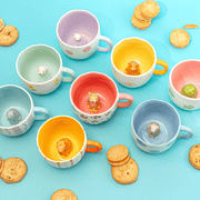 Sass and Belle surprise animal mugs styled with biscuits, showing colourful mugs with hidden animal designs inside