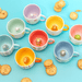 Sass and Belle surprise animal mugs styled with biscuits, showing colourful mugs with hidden animal designs inside