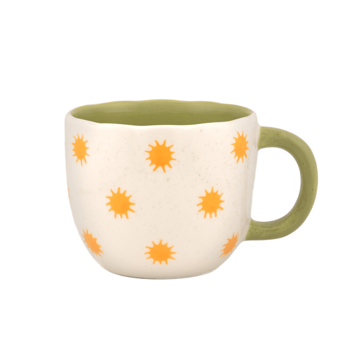 Front view of the Sass and Belle Surprise Giraffe mug with orange sun pattern, green handle and scalloped rim