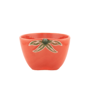Front view of a Sass and Belle tomato measuring cup with orange ceramic finish and green leaf design