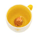Top view of Sass & Belle Highland Cow Daisy Mug – yellow interior with hidden cow figurine

