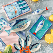 Sass & Belle sardine salt and pepper shaker displayed with coordinating fish accessories