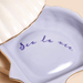 Close up of Sea La Vie message inside blue ceramic shell jewellery dish