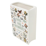 Angled top view showing sculpted pages and wide opening of the ceramic book vase.