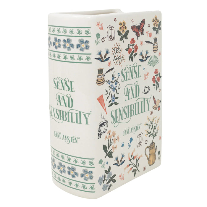 Angled front view of Sense and Sensibility ceramic book vase in cream with botanical illustrations and green lettering.