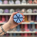 Showtime wax melt segments held in hand with colourful wax melt display in the background