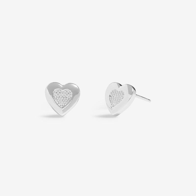 “Front view of silver‑plated heart stud earrings with pavé centre”
