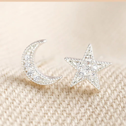 Mismatched silver moon and star stud earrings with clear crystal sparkle