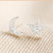 Mismatched silver moon and star stud earrings with clear crystal sparkle