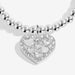 Close-up of the Joma Jewellery heart charm on the Mother’s Day Bracelet, with sparkle detail and cut-out mini hearts.