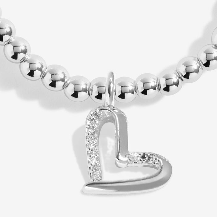 Close-up of Joma Jewellery sparkly heart charm with crystal-style detail on a silver-plated beaded Bracelet.