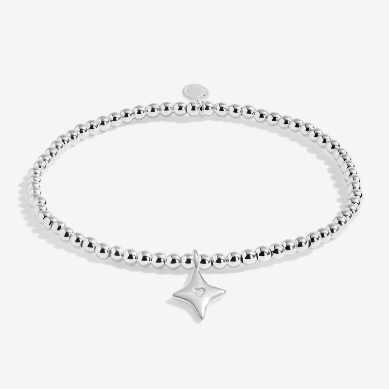 “Full product shot of silver beaded ‘Wish’ bracelet with star charm on white background”
