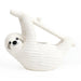 White ceramic sloth chia planter hanging from a branch on a plain white background
