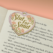 Slut For Smut magnetic bookmark marking a page in a book