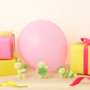 Smiski Birthday Series figures displayed with a balloon and presents
