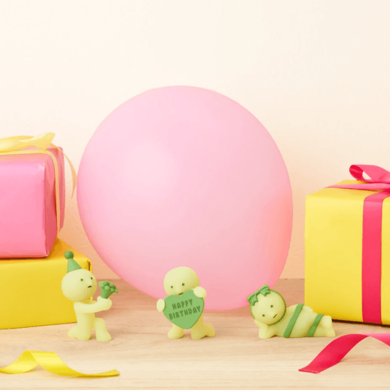 Smiski Birthday Series figures displayed with a balloon and presents