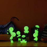 Six Smiski Dressing Series figures glowing green in the dark