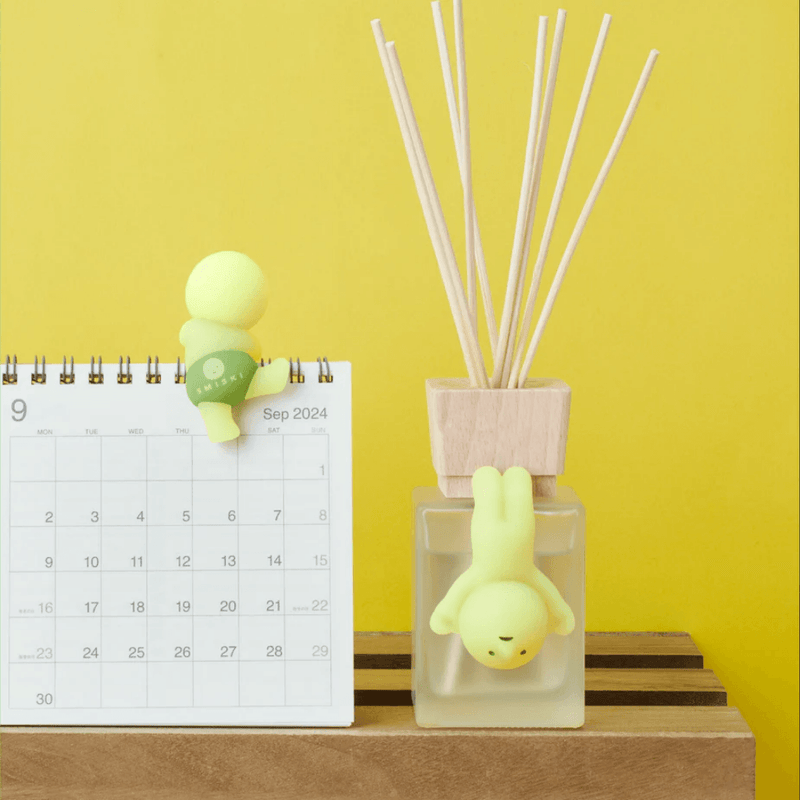 Smiski Hippers decorating a desk calendar and reed diffuser