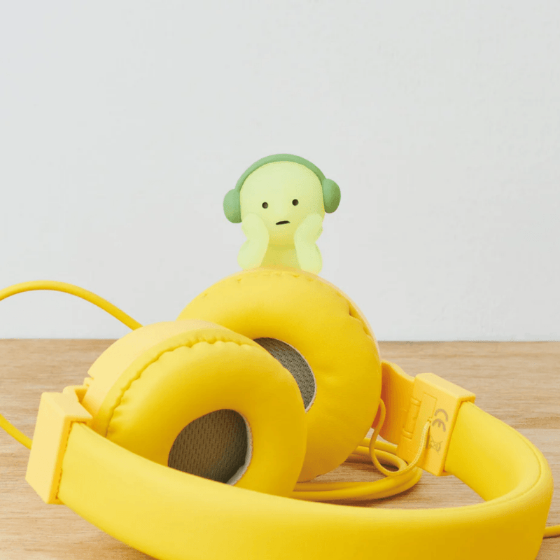 Smiski Hippers figure displayed with yellow headphones