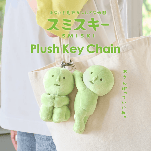 Smiski Hanging On and Hugging Knees plush keyrings hanging from a tote bag