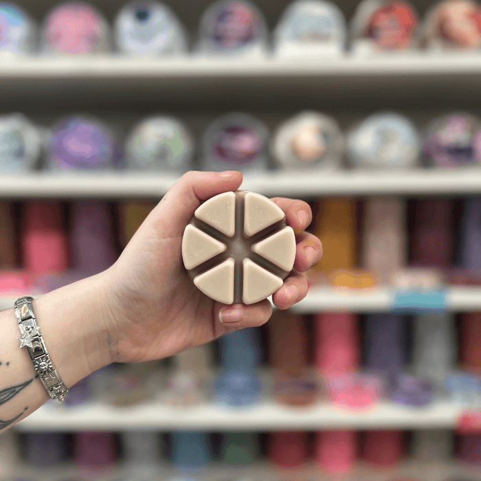 Smoked Vanilla cream segmented wax melt held in hand