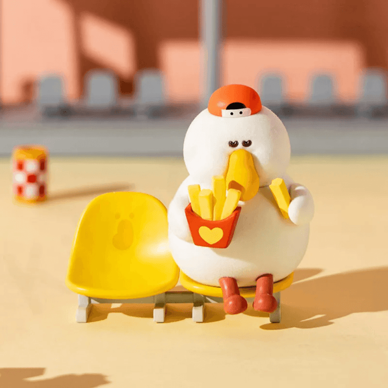 Sneaky Fatgoose relaxing on a yellow bench with a carton of chips