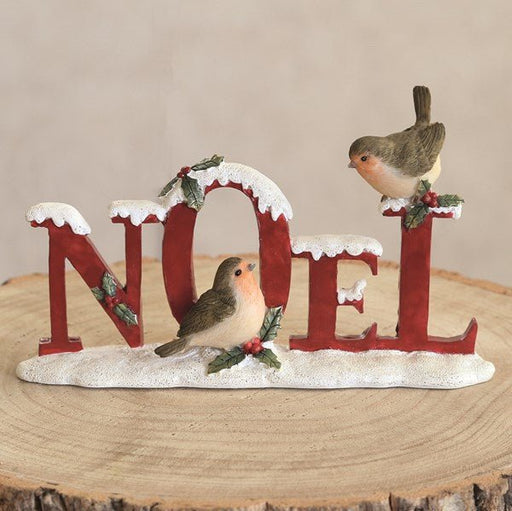 Traditional red Noel ornament with robins on a snowy base

