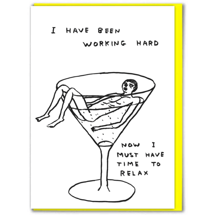 Front of David Shrigley greeting card showing a person reclining in a martini glass with the caption “I have been working hard, now I must have time to relax.”