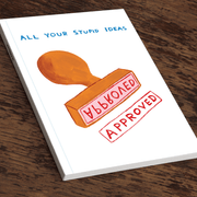 Angled view of David Shrigley “All your stupid ideas” A5 notebook on a wooden table.

