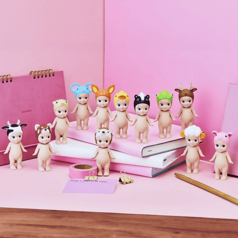 Sonny Angel Animal Series 2 figures displayed with notebooks and stationery