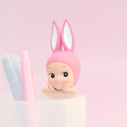 Pink Rabbit Sonny Angel Hipper peeking over the edge of a pen pot