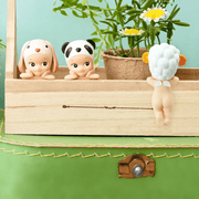 Sonny Angel Hippers figures attached to a wooden shelf beside flowers