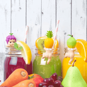 Grape, Pineapple and Pear Sonny Angel Hippers displayed with colourful fruit drinks