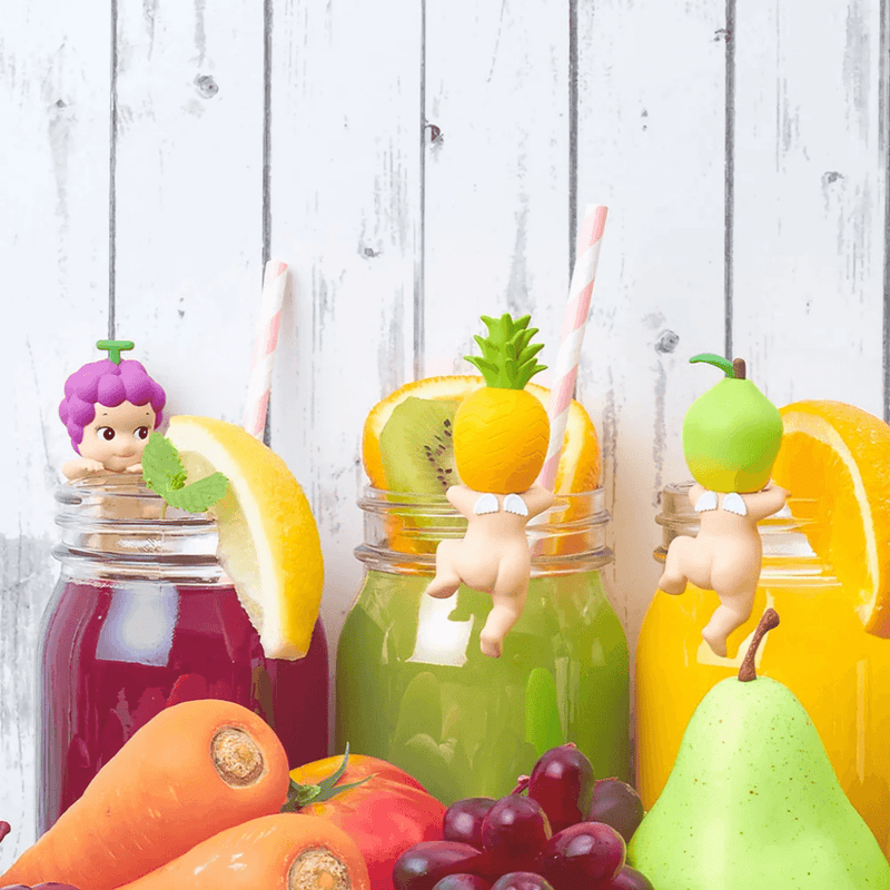 Grape, Pineapple and Pear Sonny Angel Hippers displayed with colourful fruit drinks