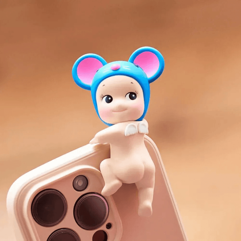 Sonny Angel Hippers Looking Back Mouse figure attached to a smartphone