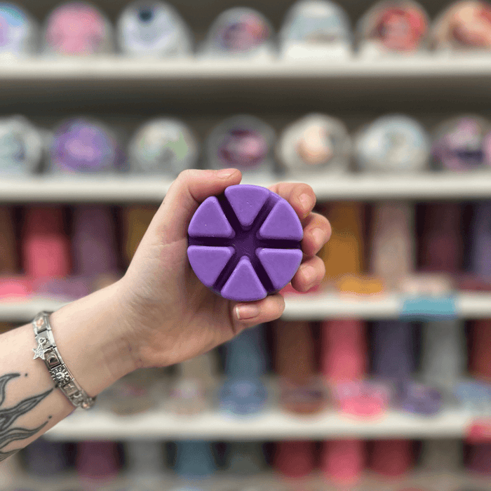 Spiced Blackberry Jam purple segmented wax melt held in hand