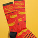 Fun Club red socks with yellow hand graphic and “I Can Do All Things Through Spite” quote – a bold and funny womens gift.

