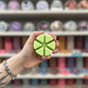 Spring Breeze green segmented wax melt held in hand
