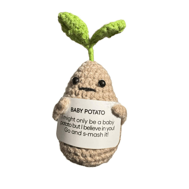 Crocheted sprouted baby potato decoration holding a motivational message card on white background