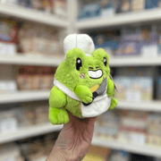 Squishable Alter Ego Frog Chef plush toy angled view held in hand in a shop