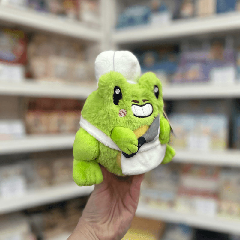 Squishable Alter Ego Frog Chef plush toy angled view held in hand in a shop