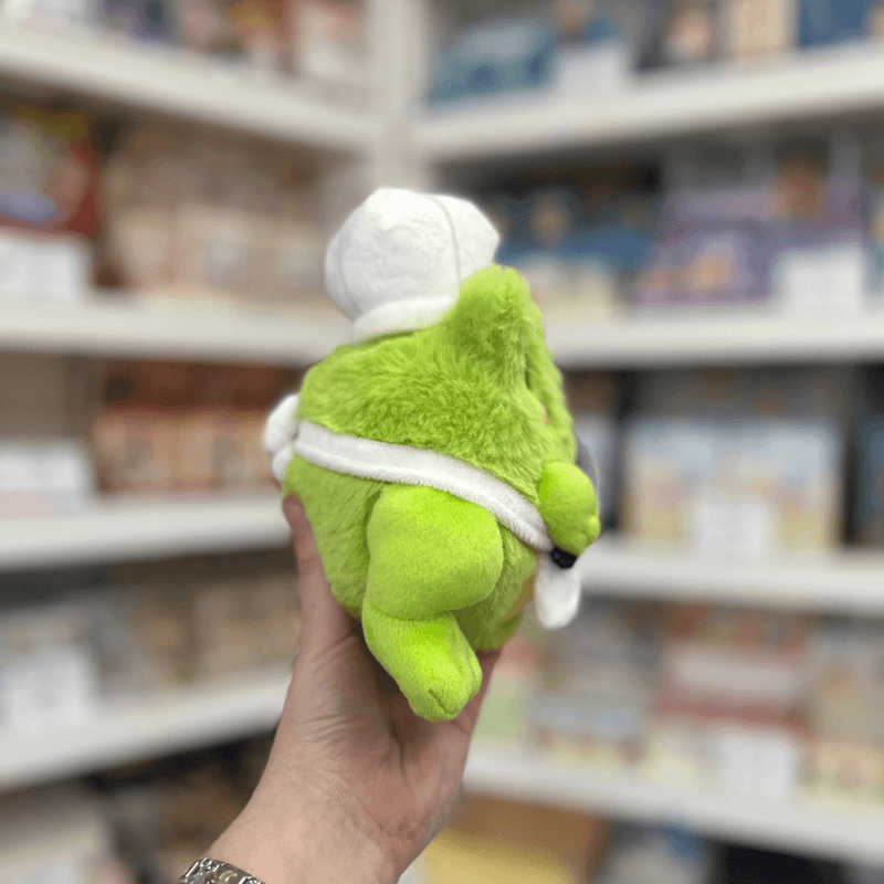 Squishable Alter Ego Frog Chef plush toy back side view held in hand in a shop