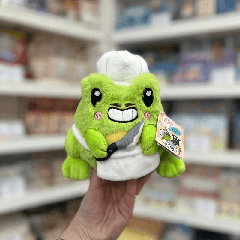 Squishable Alter Ego Frog Chef plush toy front view held in hand in a shop