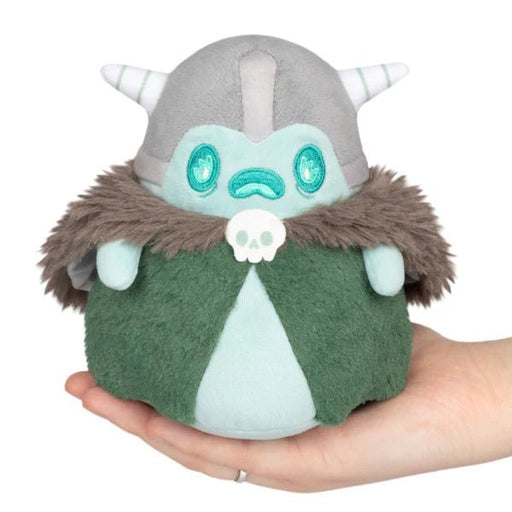Front view of Squishable Ghost Ancient plush with horned helmet, fuzzy cloak and skull clasp, held in hand