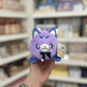 Squishable Alter Egos Magical Kitty plush toy in soft purple with blue ears, tiny wings and a dark ribbon bow
