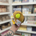 Side view of Squishable Alter Egos Plague Doctor Burger plush toy with burger bun, lime slice, plague mask and tag