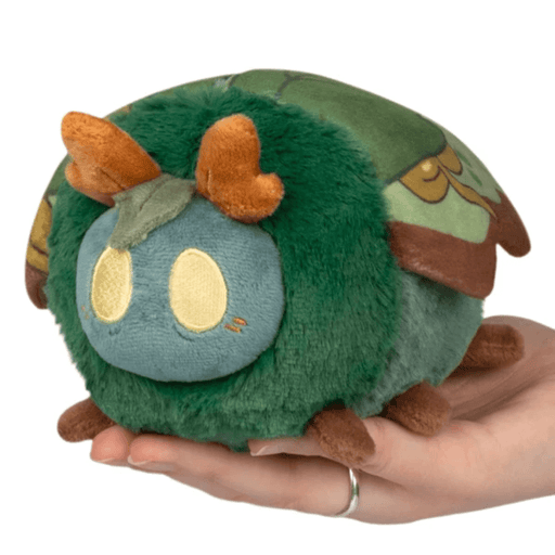 Squishable Bog Moth plush with a green body, yellow eyes and orange antennae