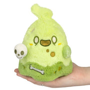 Front view of Squishable Slime Ghost plush in neon green with skull accessory, held in hand