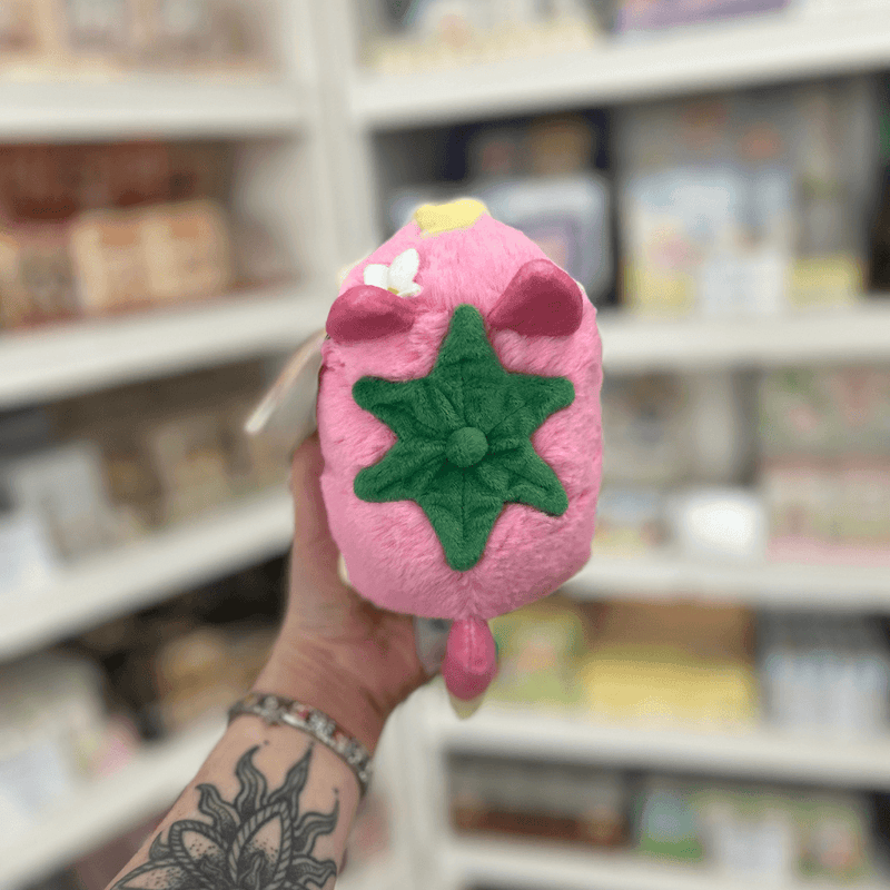 Back view of Squishable Alter Egos Strawberry Kitty plushie showing its green strawberry top, pink tail and soft plush body