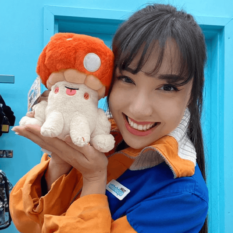 Person holding Squishable Alter Egos Toadstool plush toy with orange mushroom cap